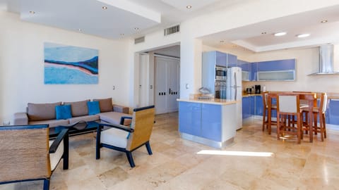 Bright open-concept kitchen and living space with modern finishes—perfect for gathering, cooking, or relaxing after a beach day.