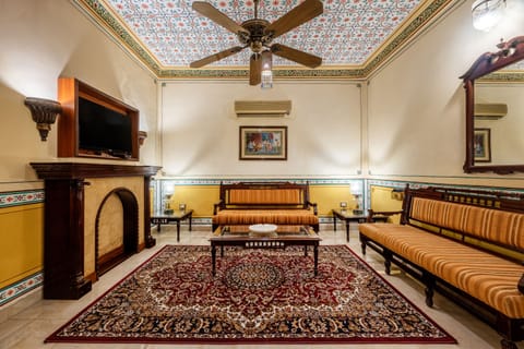 Haveli Suite | Living area | 42-inch LED TV with cable channels, TV, fireplace