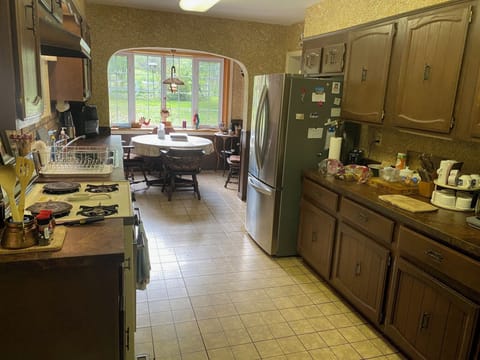 Kitchen and breakfast table with bay window look on yard, orchard, and fields.