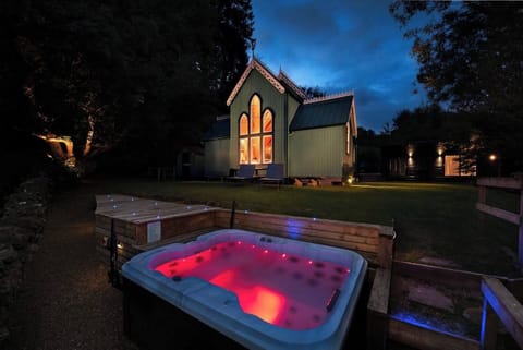 Hot Tub Area -Beautifully lite up at night so you can enjoy the night sky's in the hot tub and the drama of this extraordinary building.