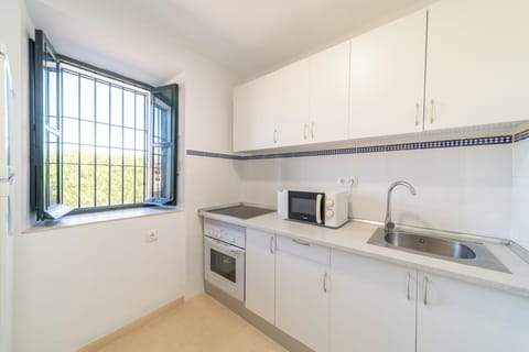 Deluxe Apartment | Private kitchen | Fridge, highchair