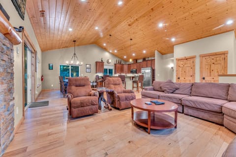 Living Room: Large l-shaped couch, 2 recliners, 55” Smart TV, gas fireplace, soaring windows, open layout, upper floor