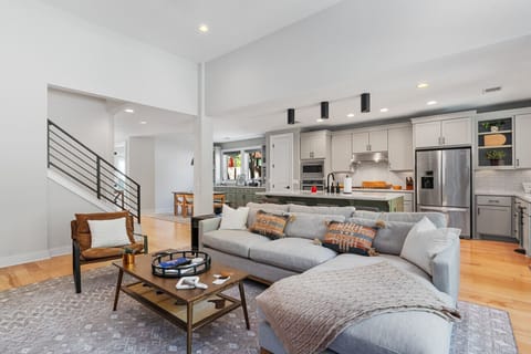 The open-concept living room offers modern furnishings and plenty of comfortable seating, making it an inviting space to relax after exploring Austin. Perfect for groups and families.