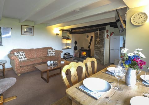 two seater sofa, coffee table, side table, dining table dressed with tablewear and fresh flowers.