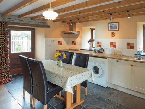 Kitchen / dining area, fitted units, table and 4 chairs, 2 windows and door to patio