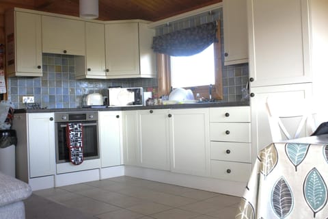 Kitchen area with electric cooker and microwave