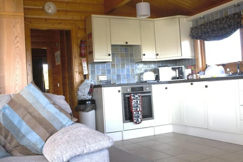 Open plan sitting/kitchen area with door leading to bedrooms