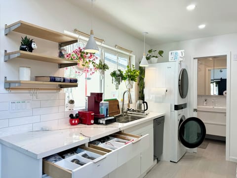 Bright kitchen with modern appliances, laundry, and stylish decor.