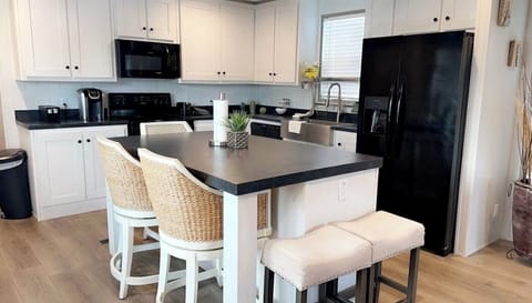 Open concept kitchen black appliances and dinning island 