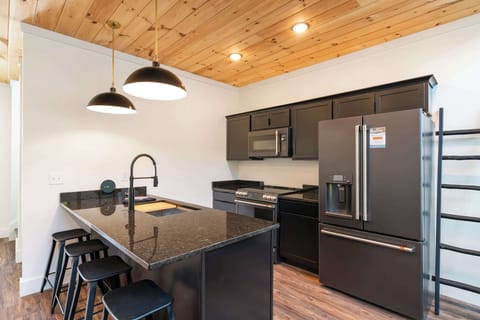 Sleek black appliances and a spacious island for culinary adventures await!