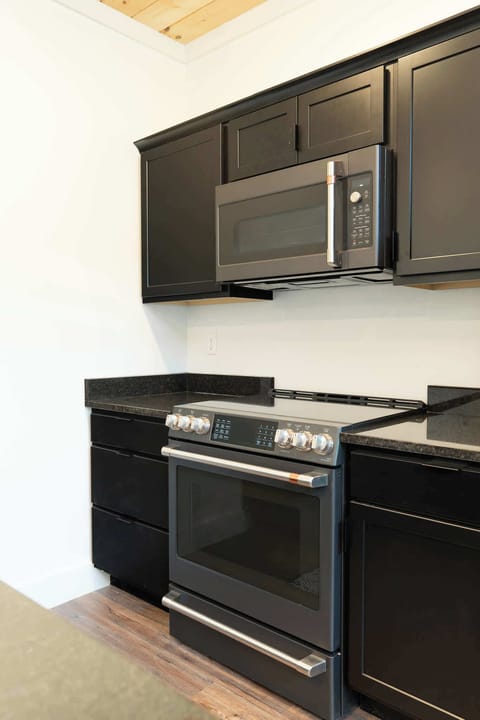 Your Modern Kitchen awaits, and whip up culinary delights with stylish appliances and sleek black cabinetry!