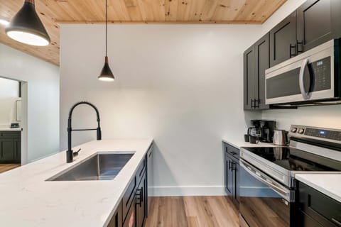Sleek fixtures and modern appliances make cooking a delight in this stylish space!
