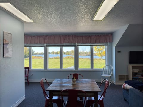 South wing 2nd floor living room has twin bed, tv, couch, and table and chairs