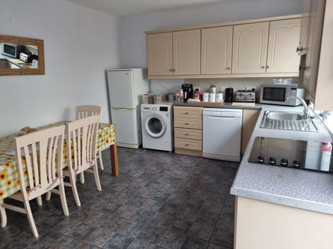 Large kitchen ,fully kitted out with all appliances including washing machine, dishwasher, dryer, fridge, microwave, toaster, air fryer, utensils etc