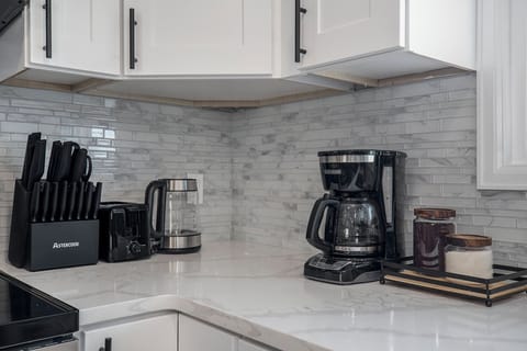The coffee corner in the kitchen is perfectly equipped for your morning brew, featuring a coffee maker and all the essentials for a delightful start to your day.