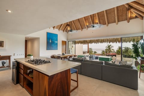 Fully equipped kitchen with handcrafted wood details, premium appliances, and a breakfast bar perfect for group stays.