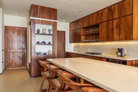 Cook in style with this fully equipped kitchen, featuring high-end appliances, rich wood cabinetry, and an inviting island.