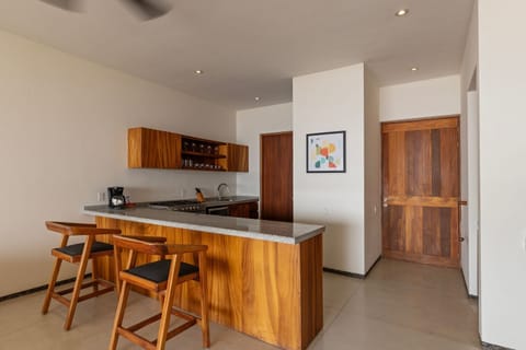 Enjoy a seamless cooking and dining experience with this well-designed kitchen, complete with a stylish breakfast bar.