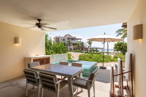 Relax on this stunning terrace featuring a private plunge pool, outdoor dining, and uninterrupted beach views.