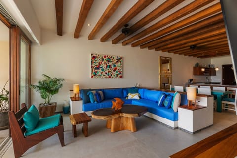 A beautifully designed living space with exposed wooden beams, vibrant decor, and a cozy, inviting atmosphere.