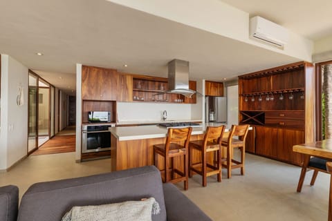 A fully equipped kitchen featuring high-end appliances, rich wooden cabinetry, and a stylish island for gathering.