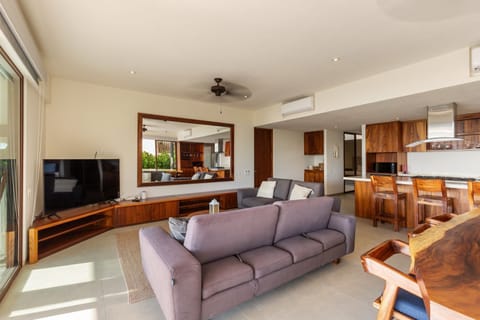 A spacious and inviting living area featuring plush seating, natural light, and an open layout for relaxation.