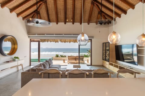 A beautifully designed open-air space combining a stylish dining area and comfortable living room, all with panoramic ocean views.