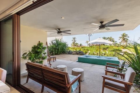 Unwind on this private terrace with cozy seating and lush greenery, offering the perfect spot to enjoy the tropical breeze and breathtaking ocean views.