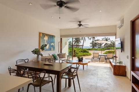 Experience seamless indoor-outdoor living with a spacious dining area, cozy lounge seating, and breathtaking ocean views.