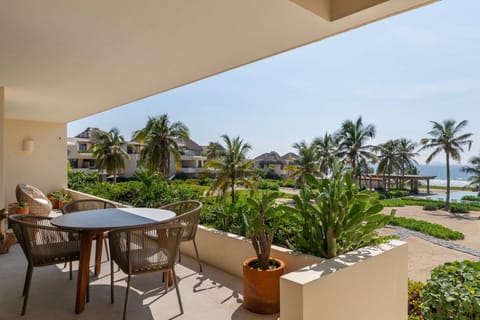 A serene outdoor dining area surrounded by lush greenery, offering a peaceful spot for morning coffee or sunset drinks.