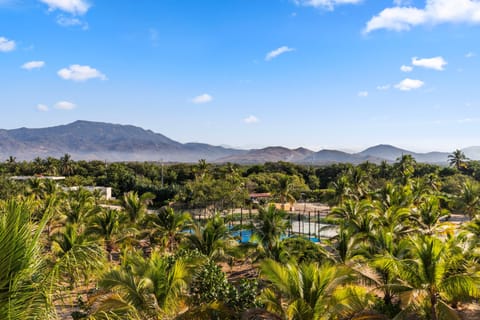 Nestled among palm trees and tropical gardens, the property features on-site paddle and pickleball courts, making it perfect for active travelers seeking both relaxation and recreation in a natural setting.