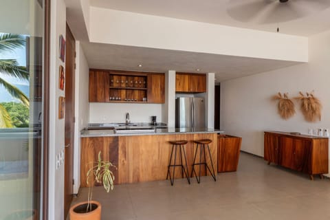 A stylish kitchen with high-end appliances and elegant wooden finishes, designed for both functionality and aesthetics.