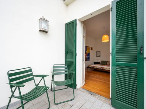 Furniture, Building, Green, Chair, Door, Lighting, Wood, Houseplant, Flooring, Wall