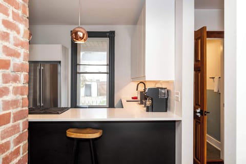 The sleek, open kitchen offers ample space & every home comfort