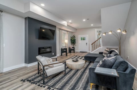 Modern spacious living area with TV and fireplace