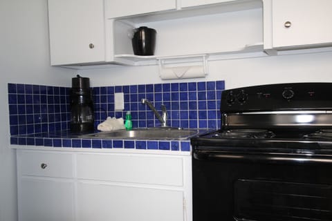 Fridge, microwave, coffee/tea maker, cookware/dishes/utensils