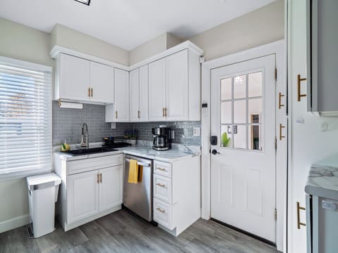 This kitchen is a culinary dream come true!  The crisp white cabinets and marble countertops create a stunning backdrop for any meal prep.  So much potential!