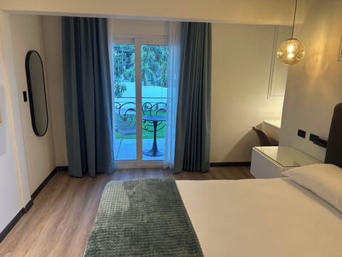 Junior Room, Garden View | In-room safe, desk, laptop workspace, iron/ironing board