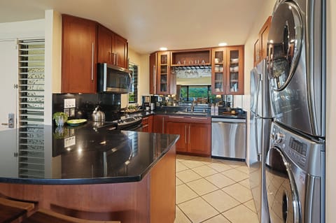 The kitchen has wide counter spaces and stainless steel appliances with an in-unit washer and dryer.