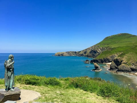 Statue of St Crannog overlooking the beach at Llangrannog