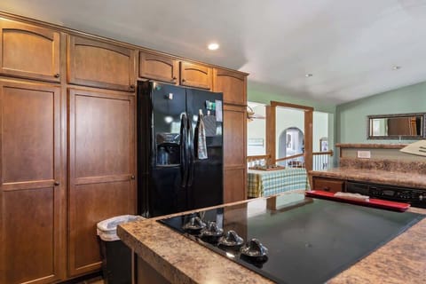 Spacious side-by-side refrigerator with ice maker, water dispenser, countertop cooking, and ample storage space.