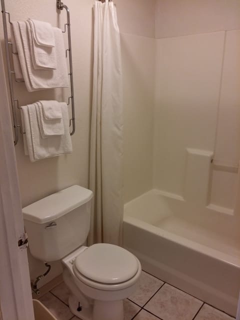 Efficiency Room, 1 Queen Bed, No Window | Bathroom | Deep soaking tub, free toiletries, hair dryer, towels