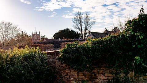 Garden views stretch across the rooftops to the village church