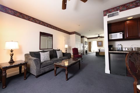 Suite, 1 King Bed with Sofa bed, Balcony, City View | Living area | Fireplace