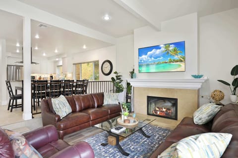 Cozy and spacious living area with TV and fireplace