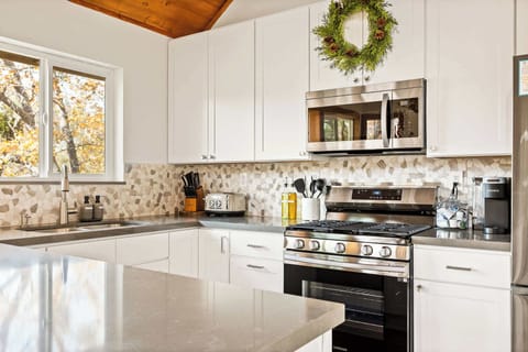 The chic, updated kitchen offers ample space & all the comforts of home