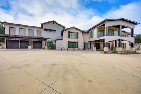 This stunning Mediterranean-style custom estate spans 7,400 sq. ft. with 5 bedrooms, an attached garage, a spacious driveway, and is beautifully situated on a vast, wooded countryside.