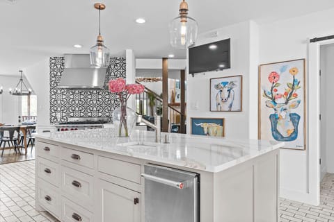 The chef’s kitchen, complete with top-tier appliances and a Wolf range, is a culinary dream. Prepare festive meals while enjoying the open-concept layout, perfect for group gatherings.