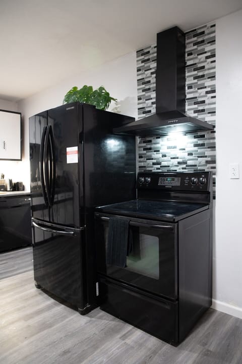 Ready for a fresh start: a full size fridge and a stove ready to turn simple ingredients into something delicious.