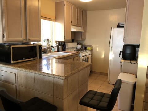 Kitchen is fully equipped, including dishwasher and dining at granite bar.